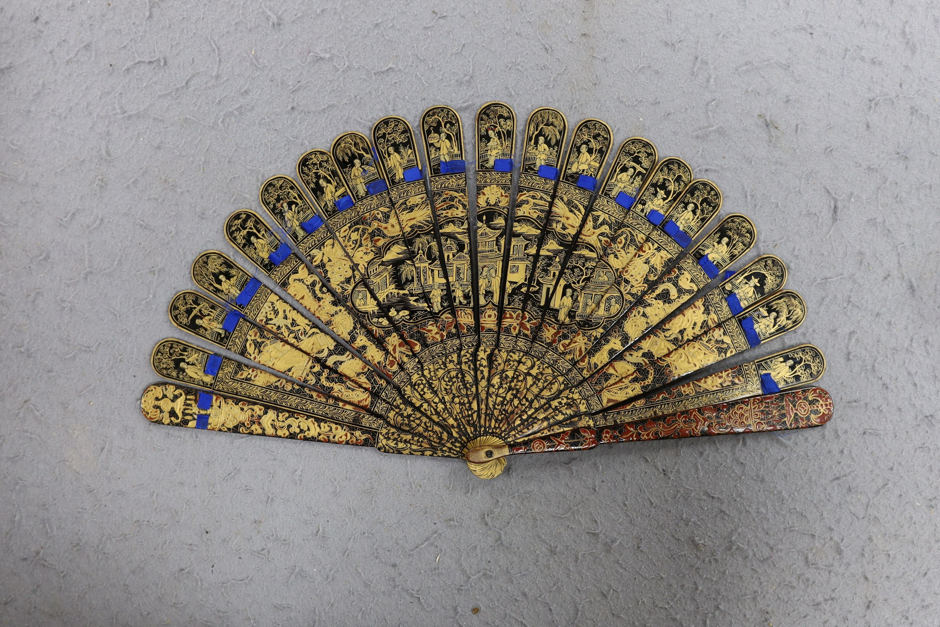 A Chinese gilt-decorated lacquer fan in a brocade covered case, 19th century